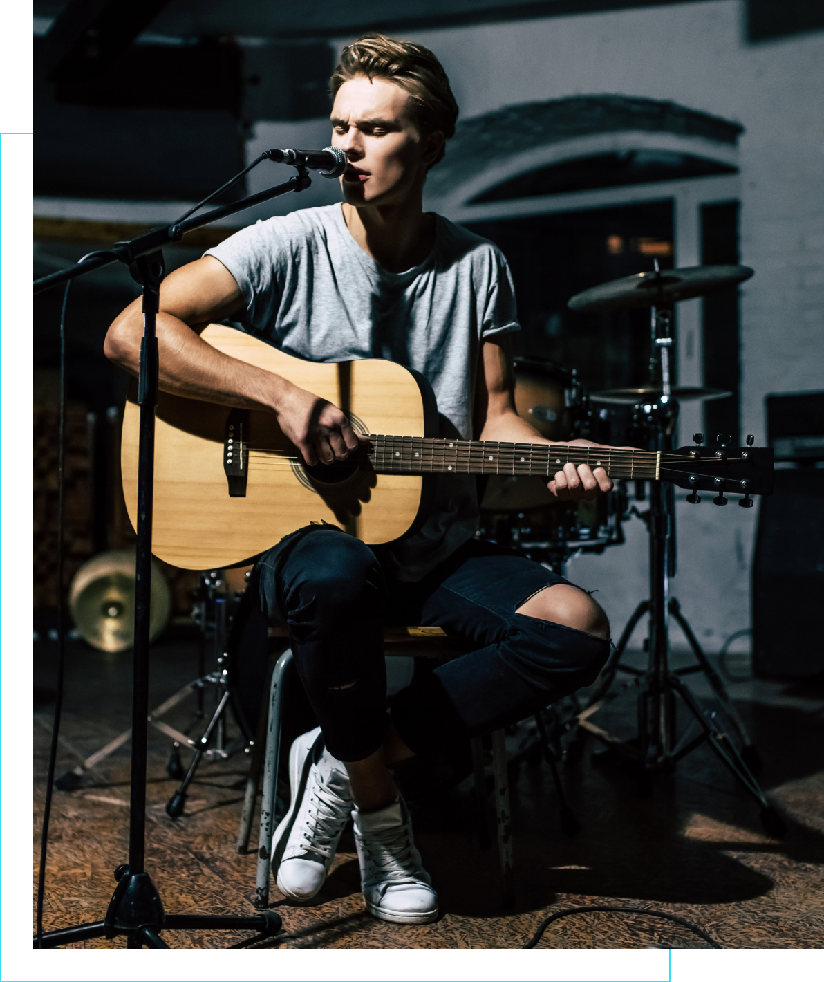 Musician playing guitar on stage